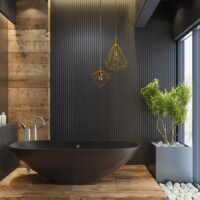 Skandinavisk badeværelse med sort badekar på et trægulv med planter ovenpå natursten