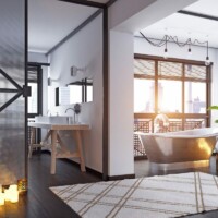 Industrielt badeværelse med rustikt gråt badekar og en grå industriel jernlåge på et mørkt trægulv